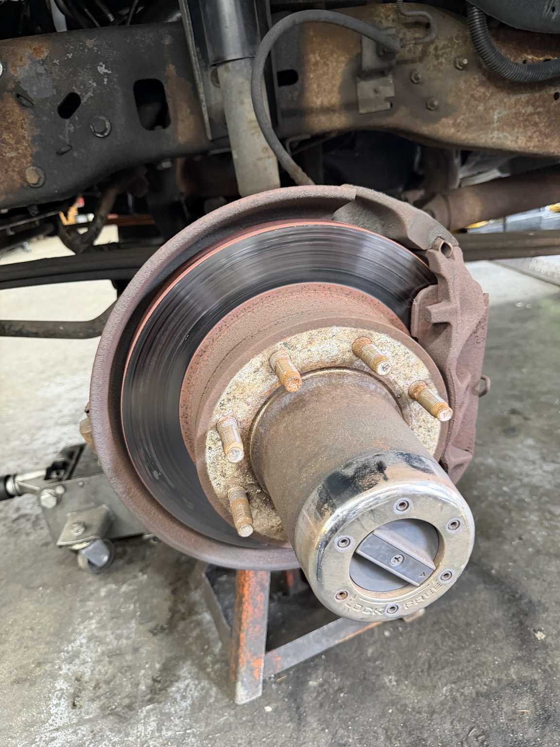 Close-up of a brake rotor and caliper serviced at Autotek