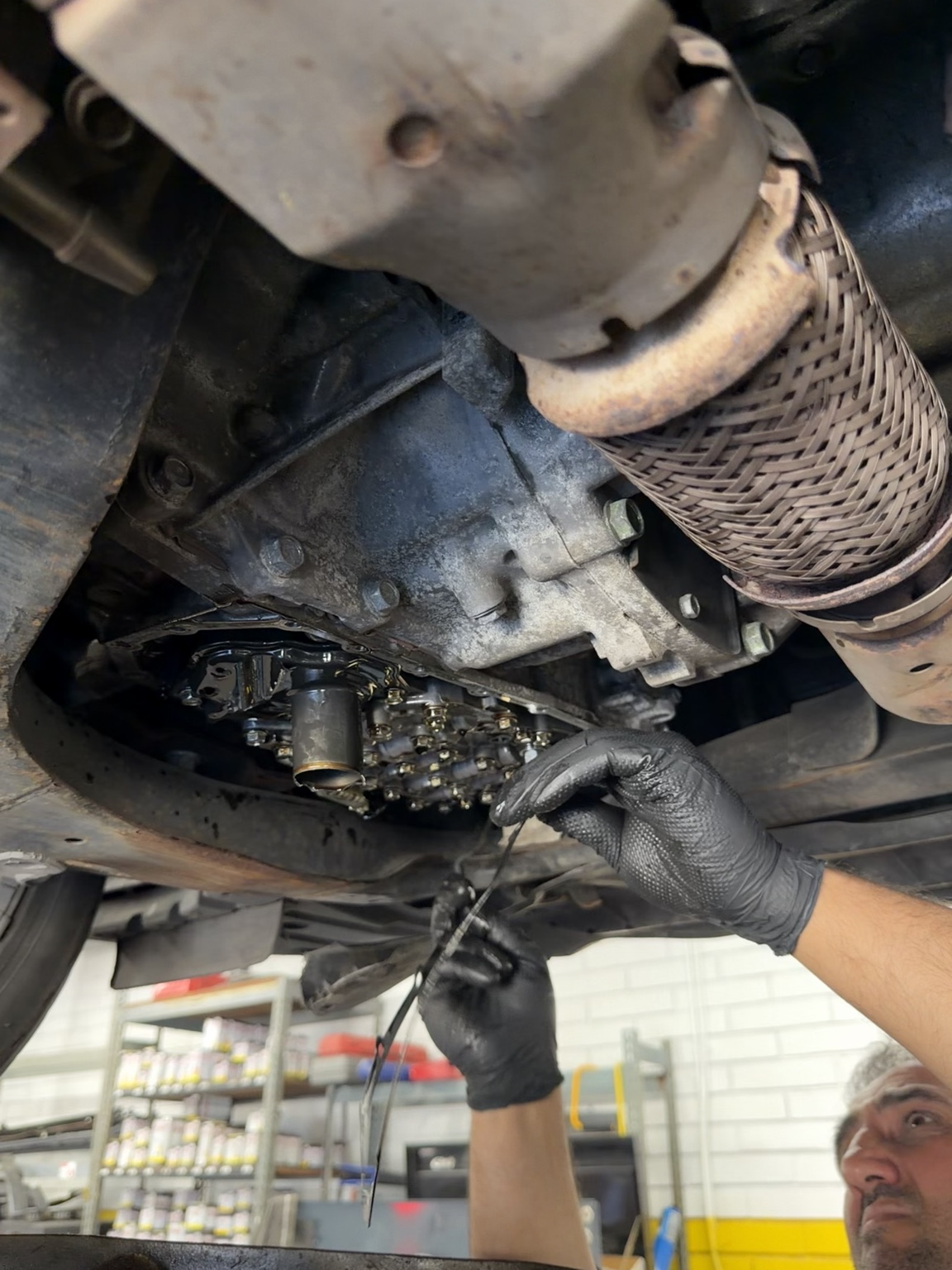Autotek technician performing an oil and filter change